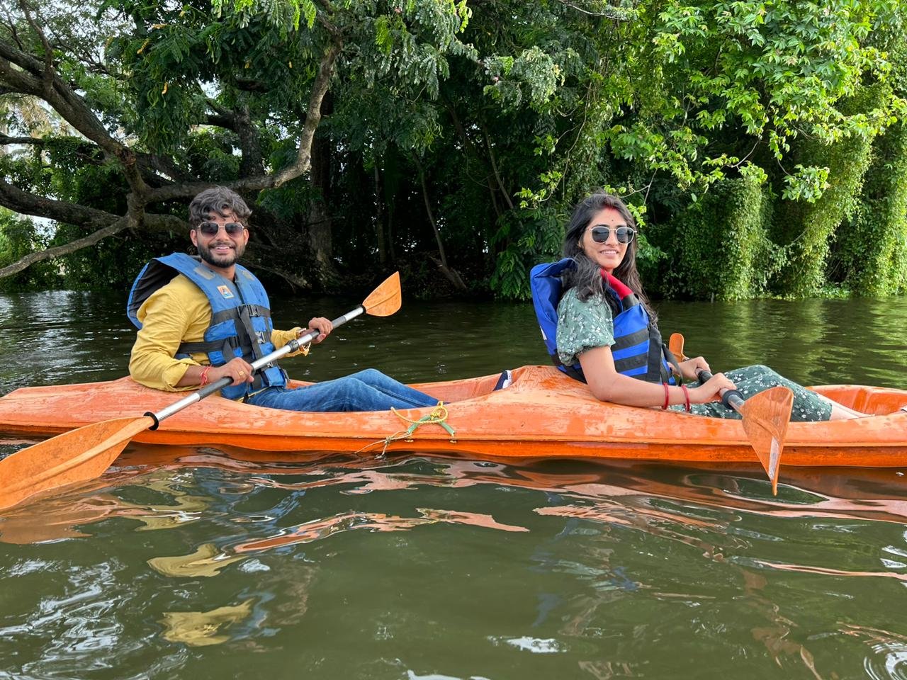 Couple kayaking in the green backwaters