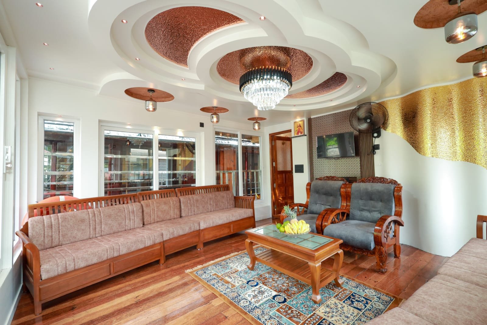 Spacious air-conditioned lounge area inside our luxury Kerala boat stay.