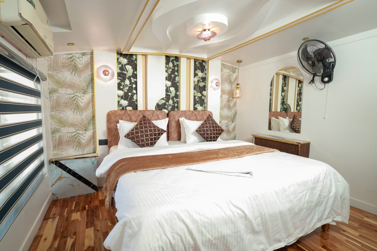 Comfortable double bed in an AC room for large family group stays.