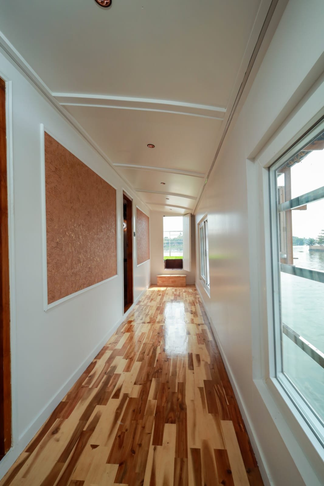Elegant wooden corridor connecting the guest rooms.