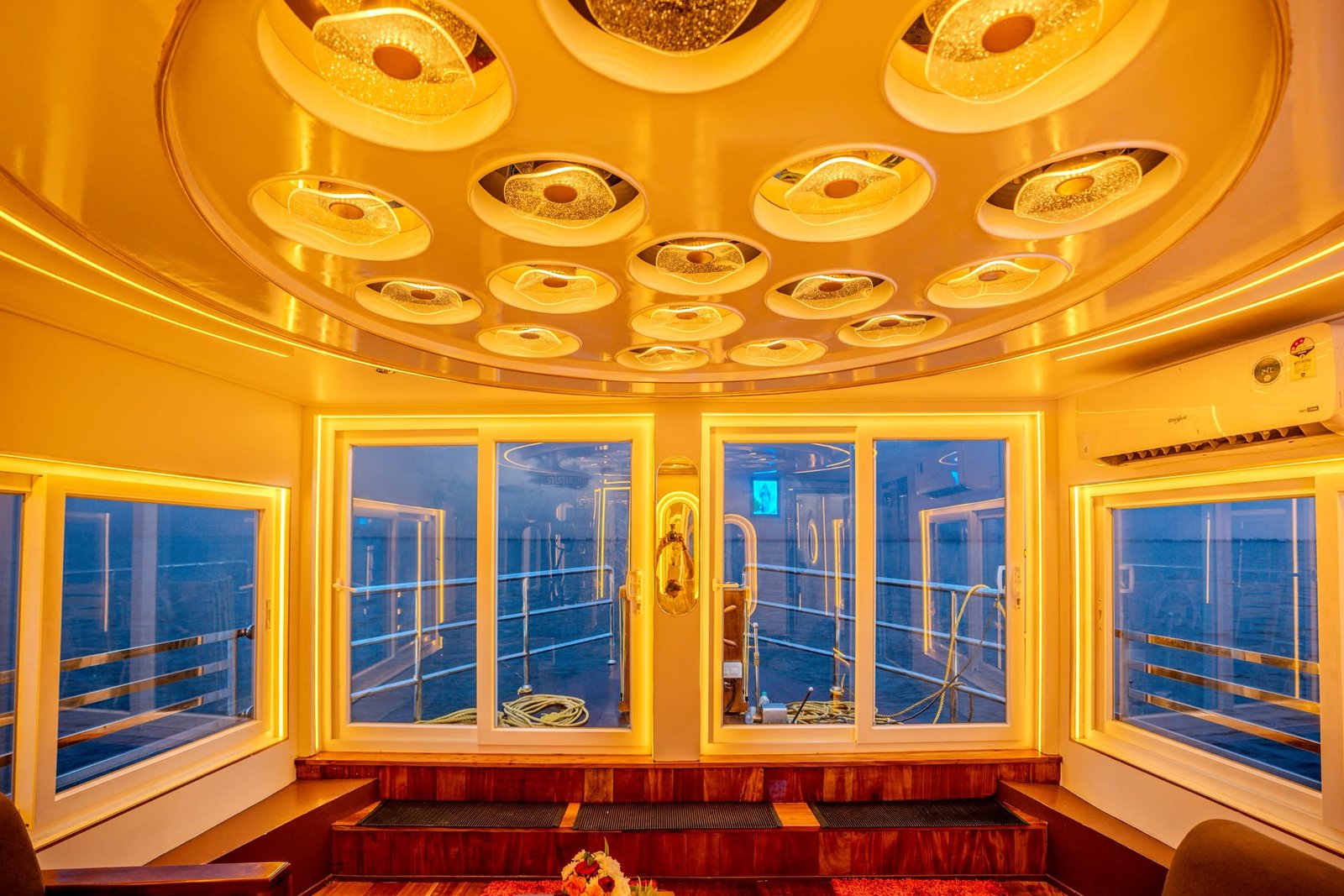 Air-conditioned indoor lounge featuring sliding glass doors and panoramic water views.