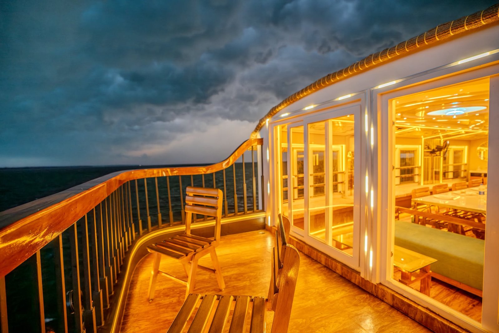 Open-air upper deck balcony offering stunning evening views on our Alleppey backwater cruise.