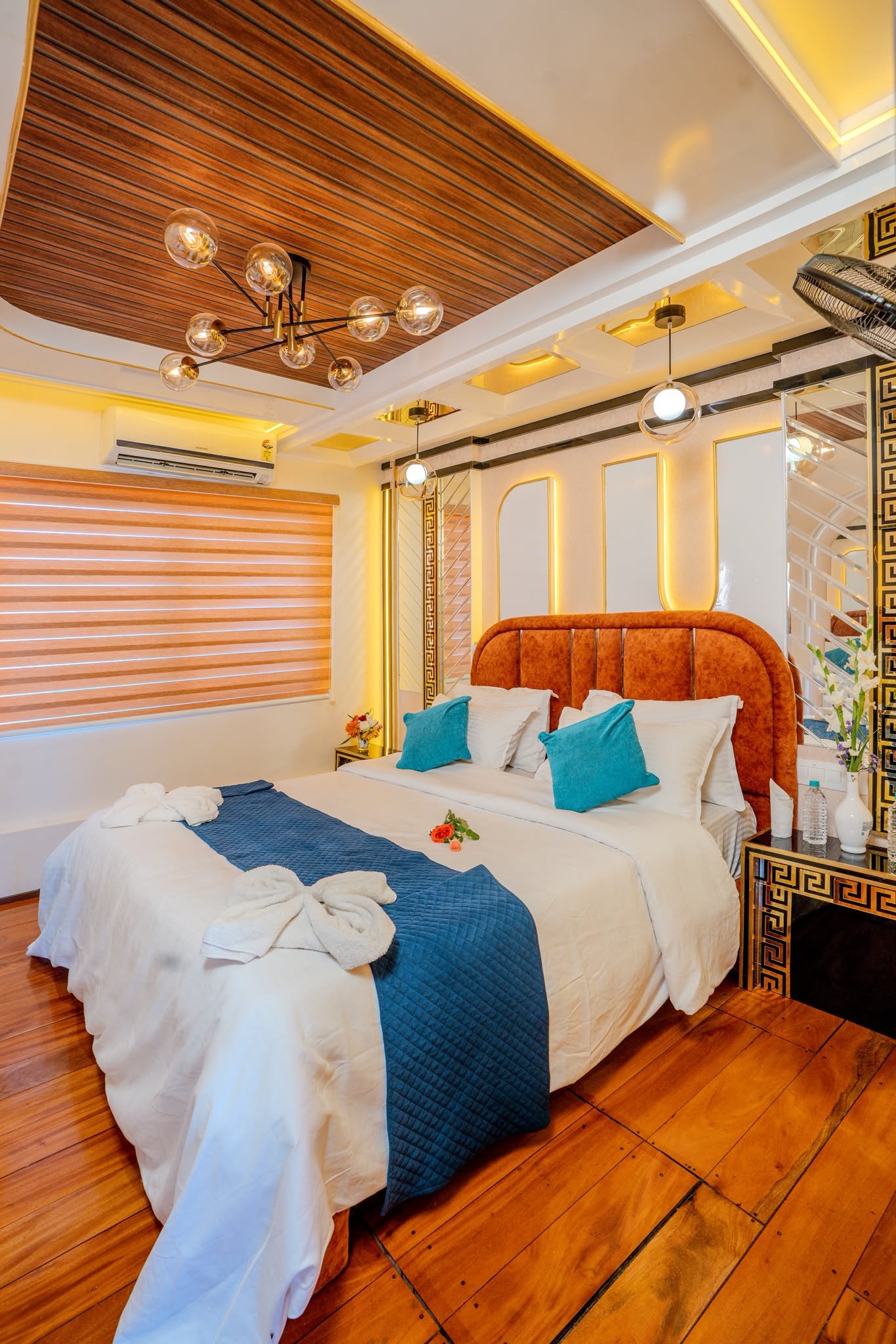 Spacious and comfortable AC bedroom with modern lighting inside a premium three-room boat stay.
