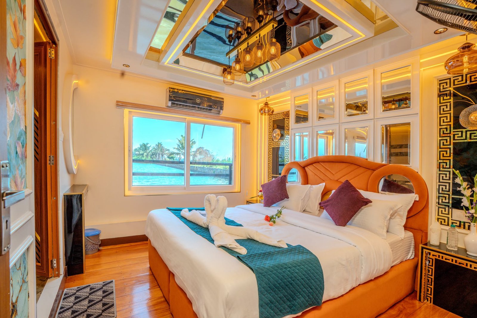 Luxurious air-conditioned master bedroom featuring modern mirror decor in our 3 bedroom houseboat Alleppey.