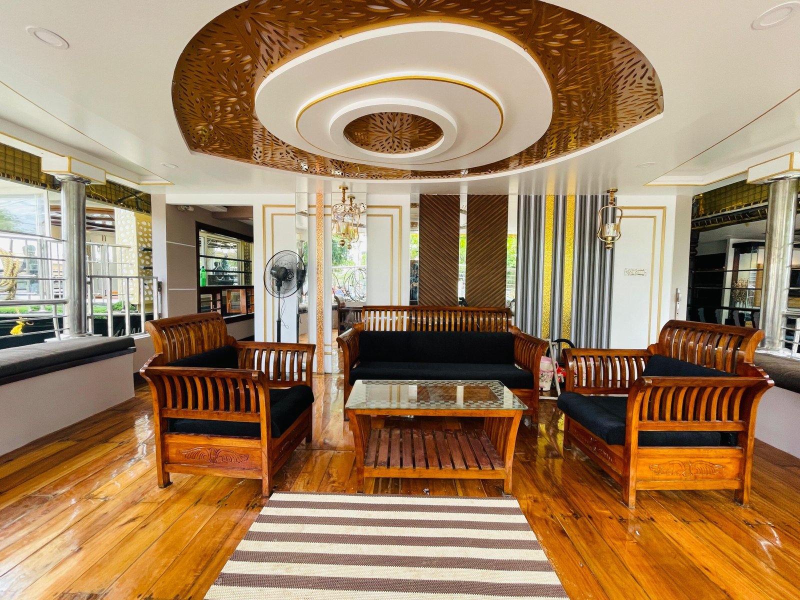 Spacious Wooden Lounge Area Comfortable living area with traditional wooden seating for large groups on a private houseboat
