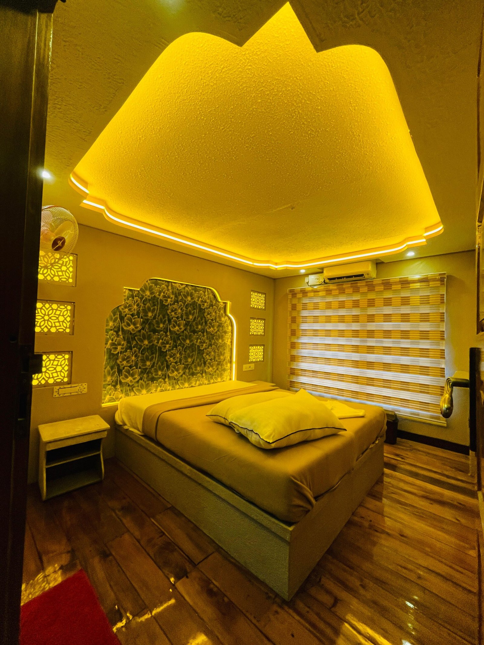 Ambient Floral AC Bedroom Private AC guest room featuring warm ambient lighting and a floral headboard