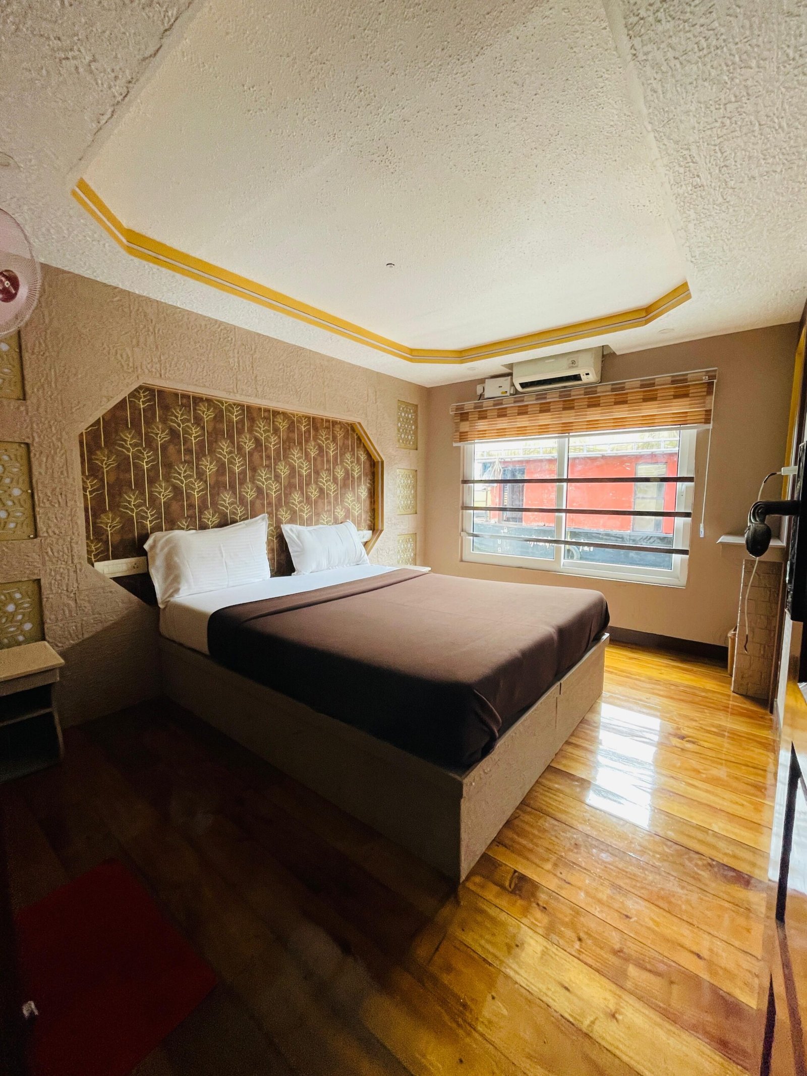 Elegant Tree Pattern Bedroom Elegant air-conditioned suite with scenic window views on a Kerala backwater cruise