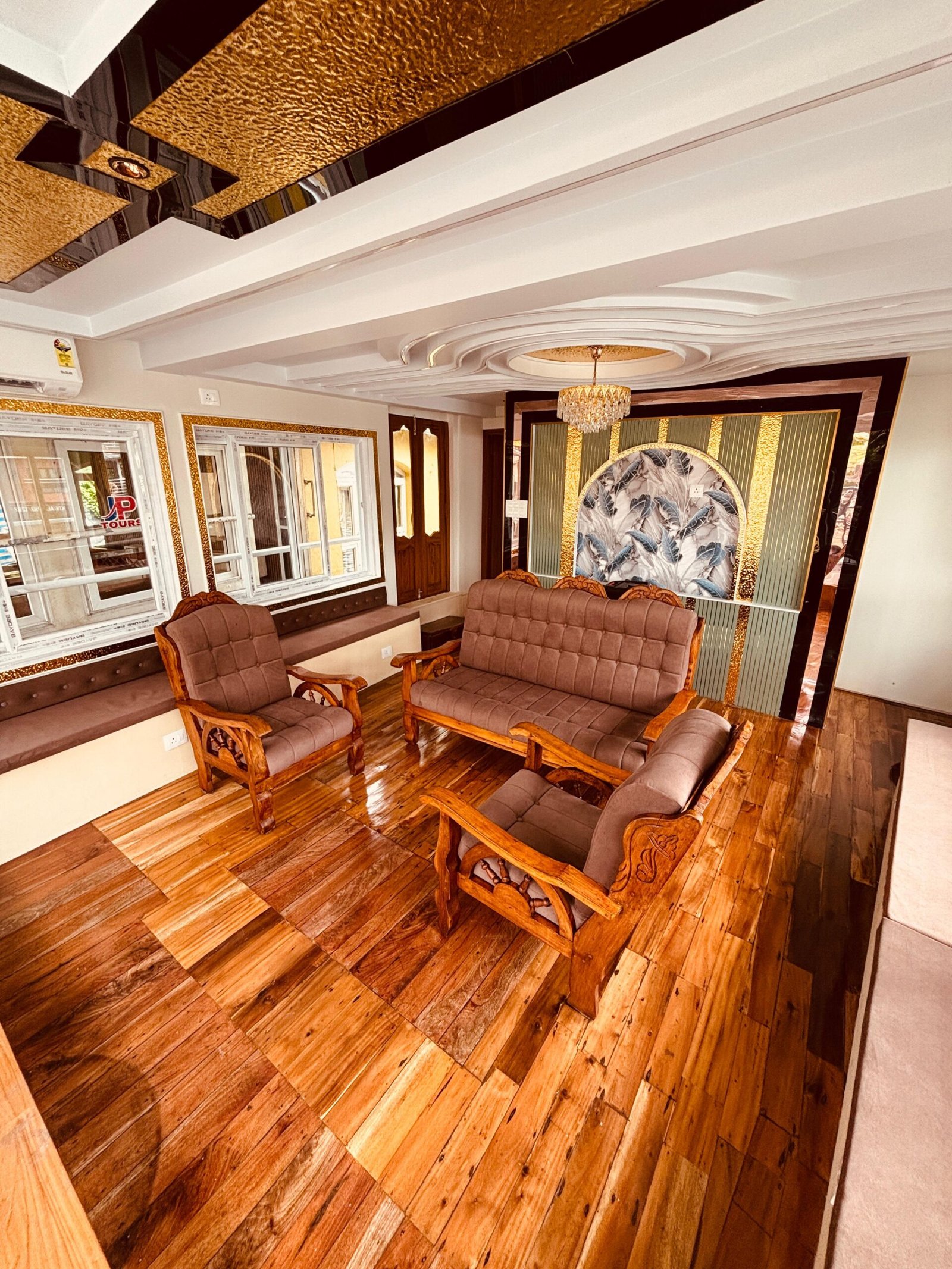 Houseboat Indoor Lounge Premium air-conditioned living room with wooden sofa seating inside a family-friendly houseboat in Alleppey.