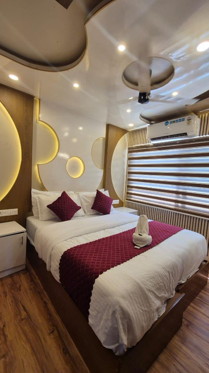 Comfortable bedding and wooden interiors inside the 10 bedroom houseboat alleppey