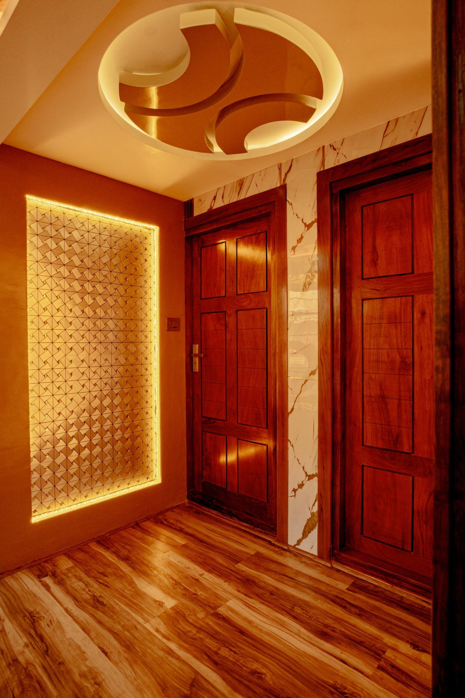 Elegant wooden doors and ambient lighting in the corridor of a 7 bedroom houseboat Alleppey