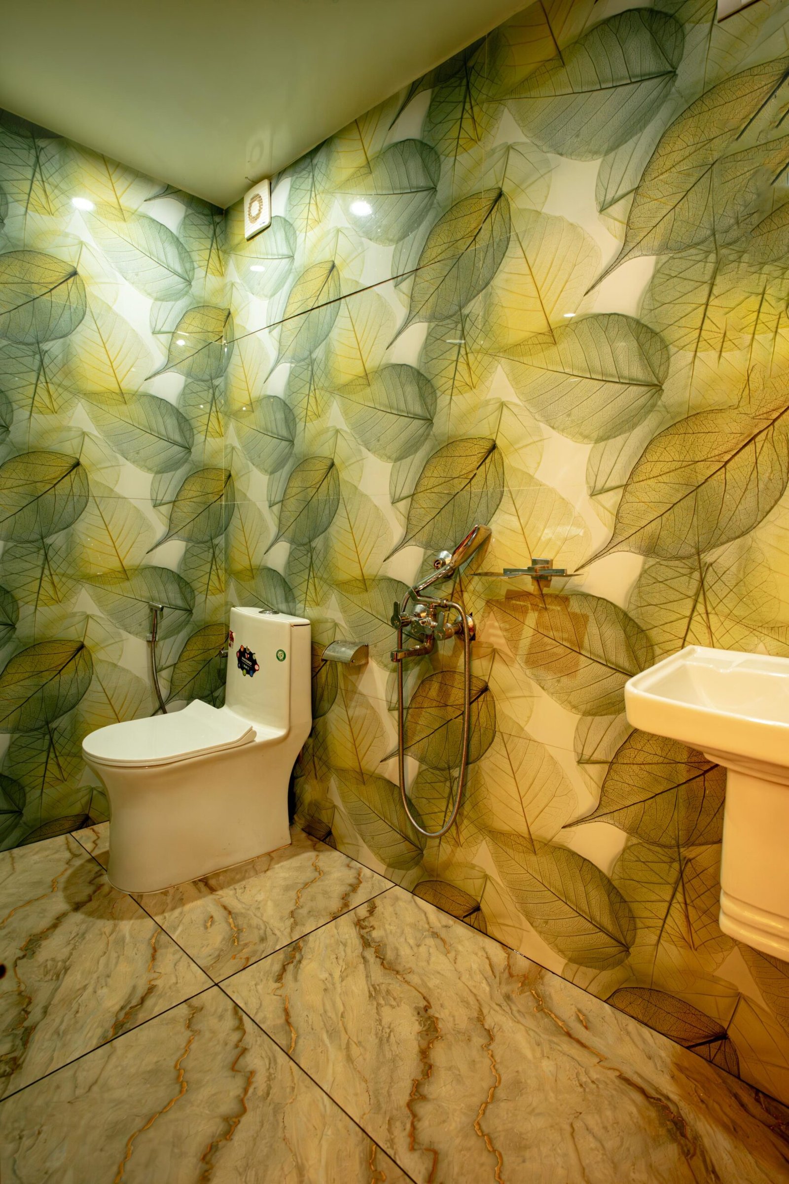 Modern attached washroom with elegant leaf wallpaper for guests on the cruise