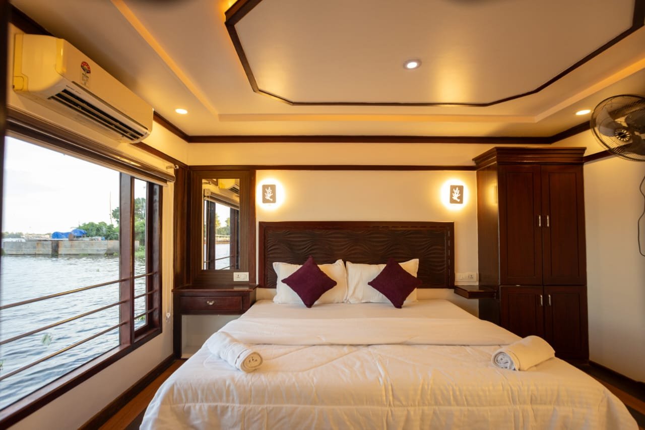 Spacious Suite - 6 Bedroom Houseboat Alleppey Spacious suite with split AC, beautiful towel art, and striped blinds in our 6 bedroom houseboat Alleppey for premium large group comfort.