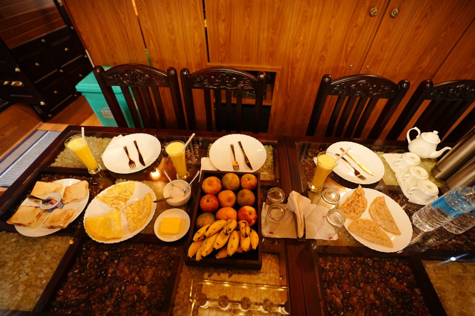 Freshly prepared Kerala breakfast with fruits and juice served onboard a 4 bedroom houseboat Alleppey.