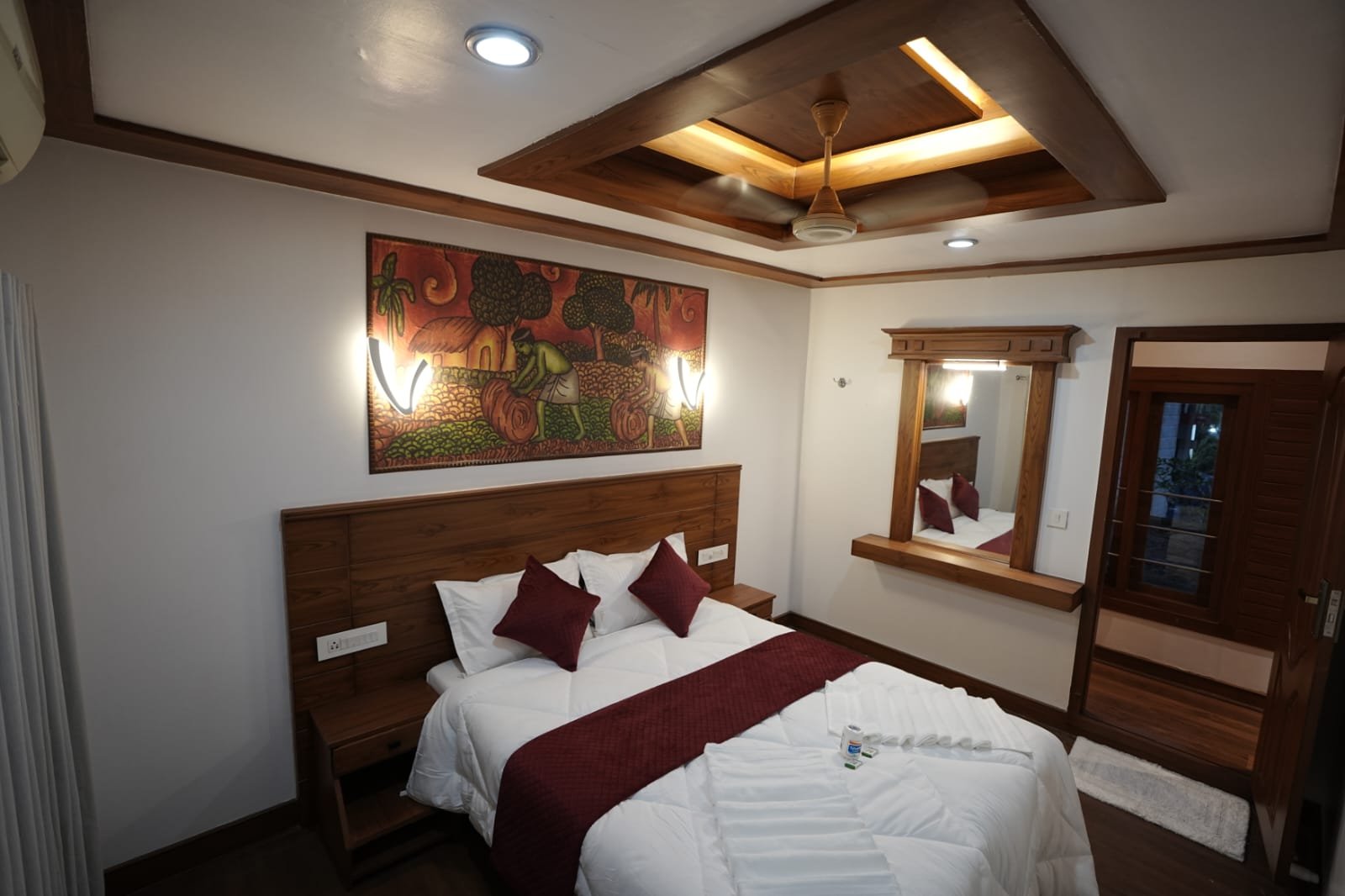 Cozy air-conditioned guest bedroom with premium bedding and sliding windows for a relaxing group stay.