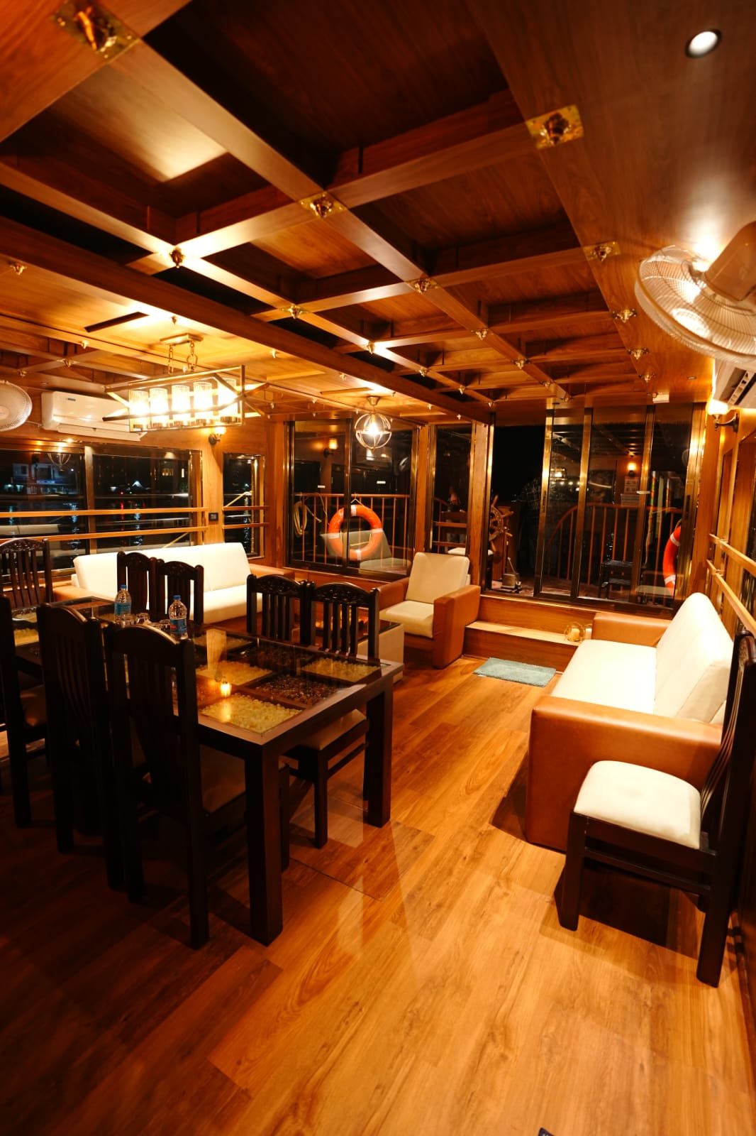 Panoramic views from the air-conditioned indoor living area of a premium Alleppey boat house.