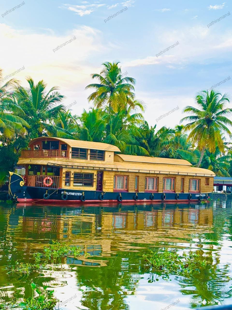 Exterior view of our premium 4 bedroom houseboat Alleppey cruising through the scenic Kerala backwaters.