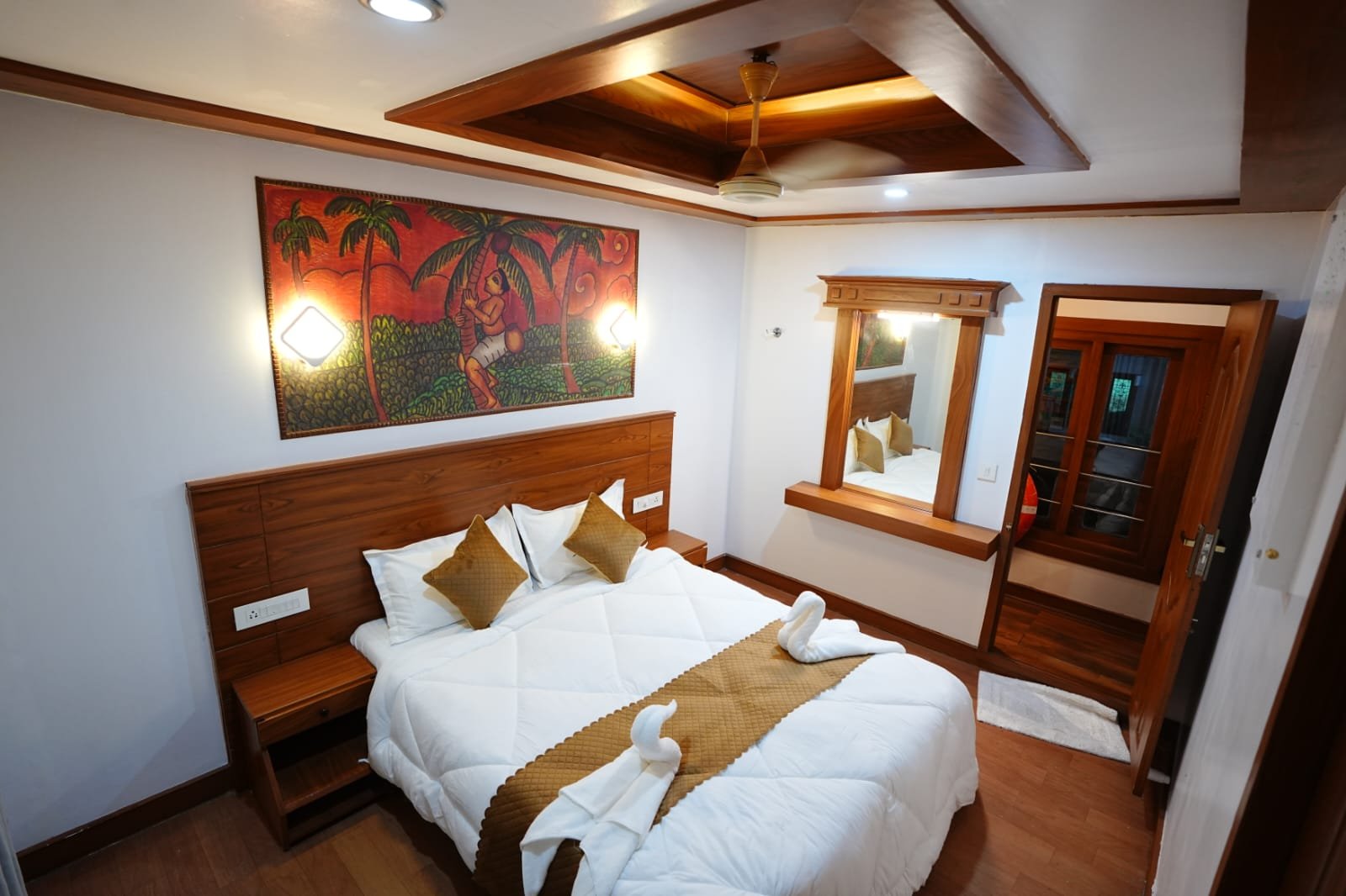 Fully equipped AC master bedroom featuring beautiful wall art in our 4 bedroom houseboat Alleppey.
