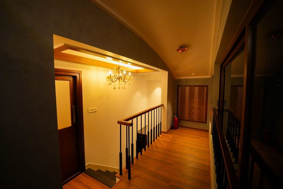 Interior Staircase of 12 Bedroom Houseboat Alleppey Well-lit wooden staircase and hallway inside the luxury 12 bedroom houseboat Alleppey