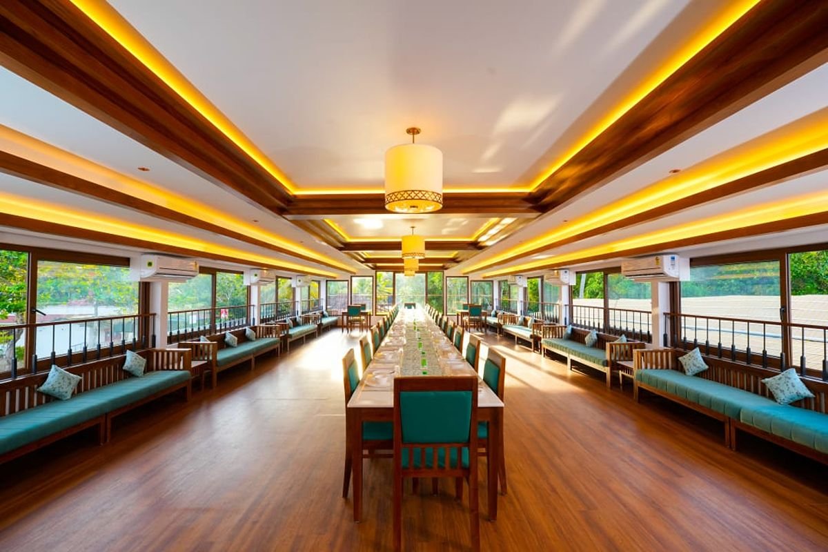 Panoramic Dining Hall of 12 Bedroom Houseboat Alleppey Expansive dining hall offering panoramic water views from the 12 bedroom houseboat Alleppey