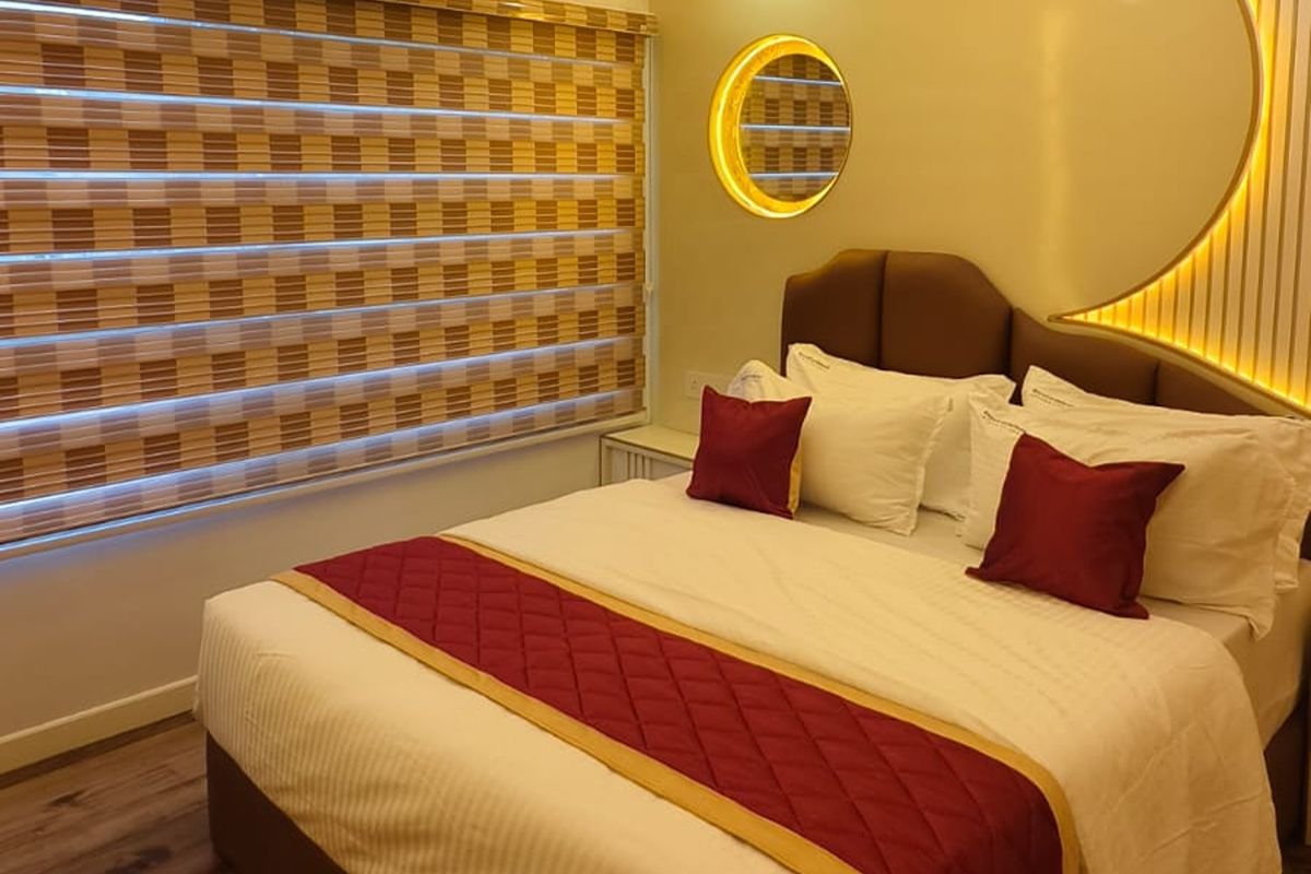 AC Bedroom - 14 Bedroom Houseboat Alleppey Cozy AC bedroom with elegant red bedding on the 14 bedroom houseboat Alleppey