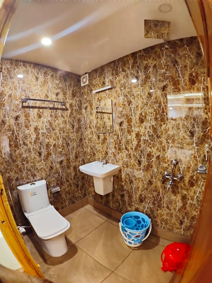 Clean attached marble bathroom with modern fittings in the 10 bedroom houseboat alleppey