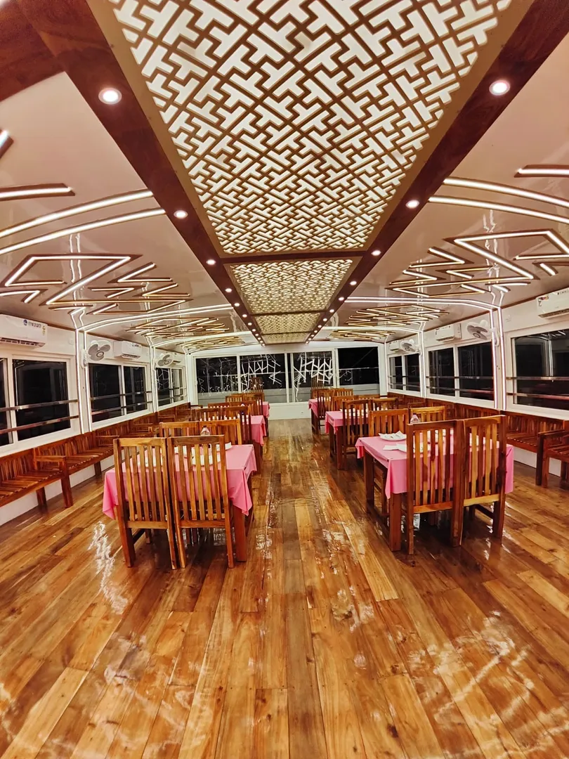 Massive dining hall with elegant table setups inside the 10 bedroom houseboat alleppey